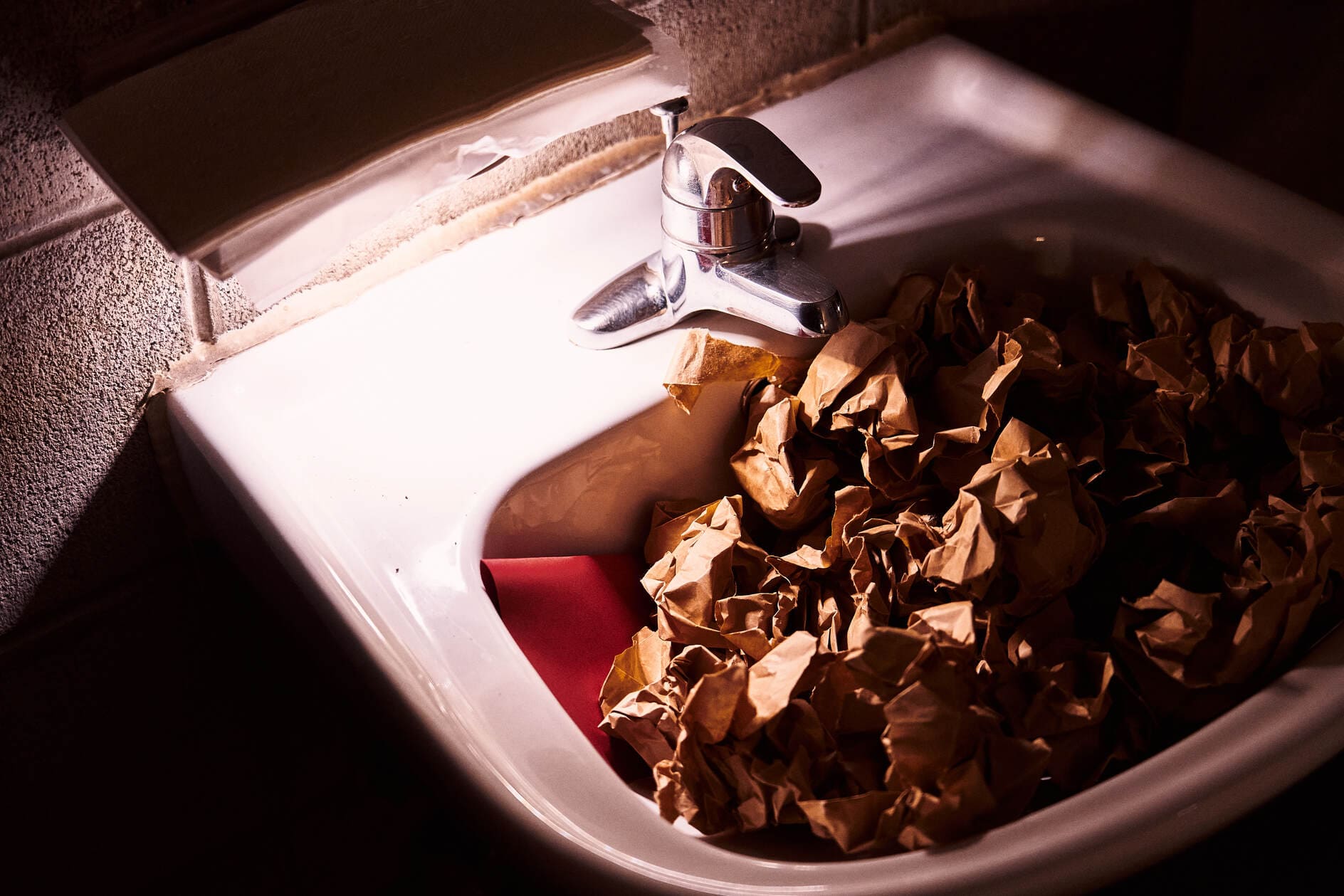 A sink full of paper bundles.